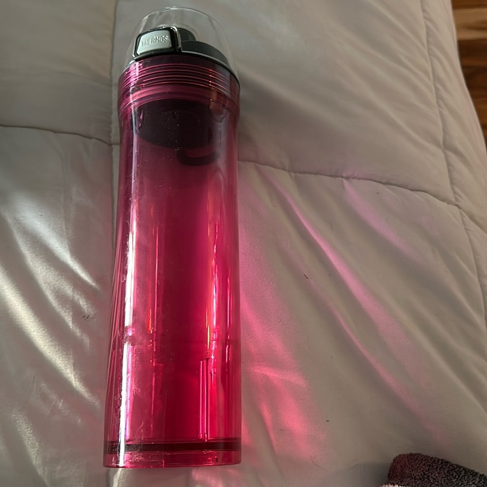 Pink see through thermos water bottle.